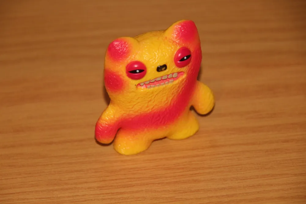 fuggler series 2 figure, with bright yellow and re. Fuggler Series 2 Figure, with bright yellow and red tie-dye design